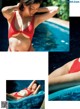 A woman in a red bikini laying in a pool.